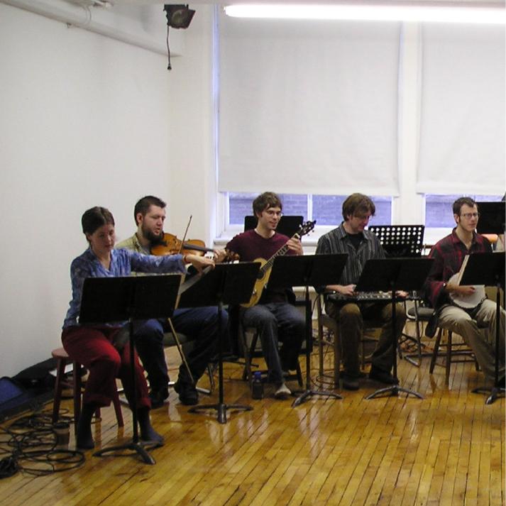 Ensemble seated with instruments